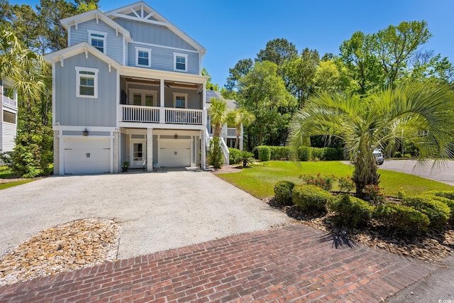 beach home featuring board and batten siding, an attached garage, and driveway
