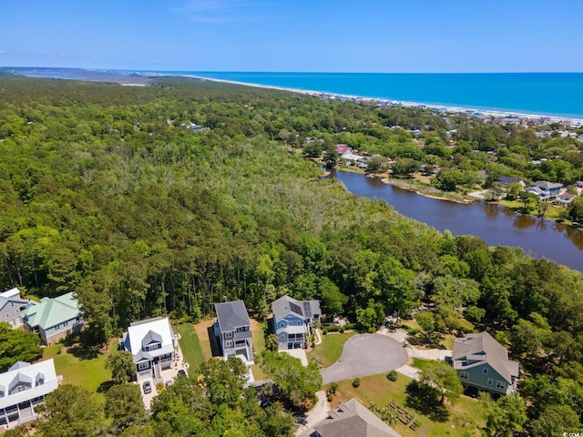 birds eye view of property featuring a water view, a forest view, and a residential view
