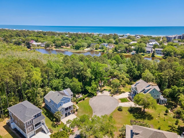 bird's eye view with a wooded view and a water view
