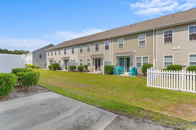 1123 Fairway Ln Unit 1123, Conway, SC 29526 - back of property featuring a patio, fence, a lawn, and a residential view