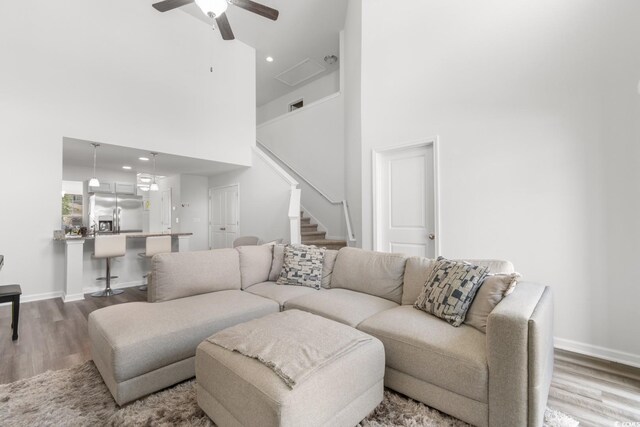 1123 Fairway Ln Unit 1123, Conway, SC 29526 - living area featuring wood finished floors, a high ceiling, stairway, visible vents, and ceiling fan