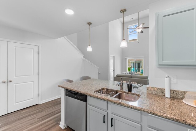 1123 Fairway Ln Unit 1123, Conway, SC 29526 - kitchen with a ceiling fan, pendant lighting, stainless steel dishwasher, light stone counters, and a sink