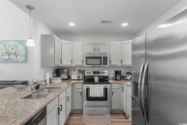 1123 Fairway Ln Unit 1123, Conway, SC 29526 - kitchen featuring wood finished floors, a sink, visible vents, appliances with stainless steel finishes, and light stone counters