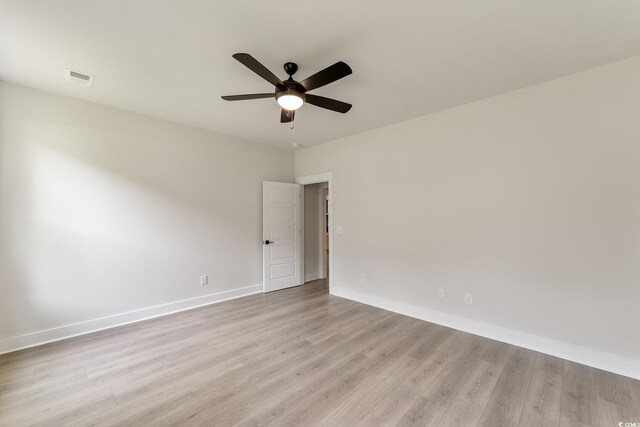 1061 Edenton Dr, Calabash, NC 28467 - empty room featuring light wood-type flooring, visible vents, baseboards, and a ceiling fan