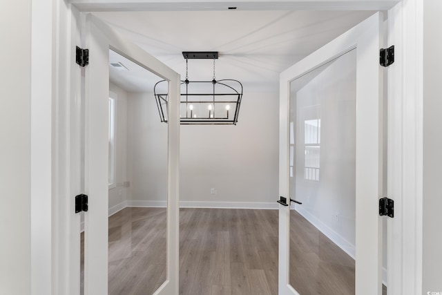 1061 Edenton Dr, Calabash, NC 28467 - unfurnished dining area with light wood-style floors, a chandelier, and baseboards
