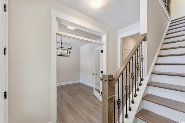 1061 Edenton Dr, Calabash, NC 28467 - stairs featuring wood finished floors, a chandelier, and baseboards