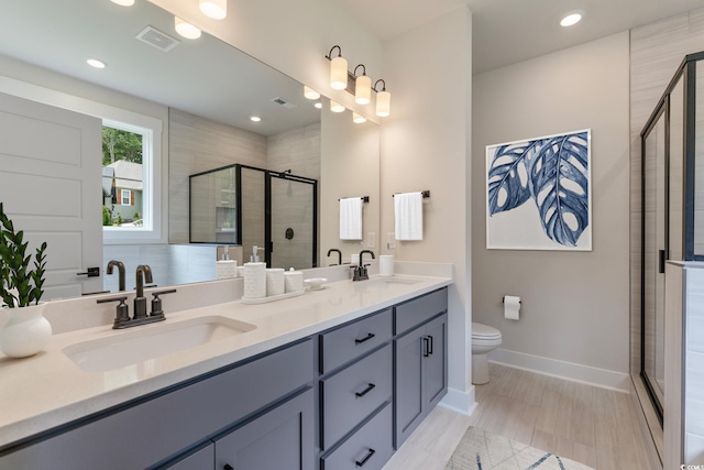1061 Edenton Dr, Calabash, NC 28467 - full bathroom with double vanity, visible vents, a shower stall, and a sink