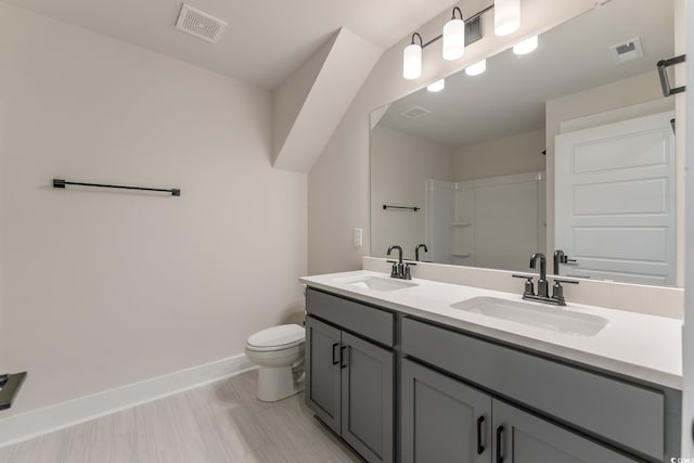 1061 Edenton Dr, Calabash, NC 28467 - bathroom featuring toilet, baseboards, double vanity, and a shower