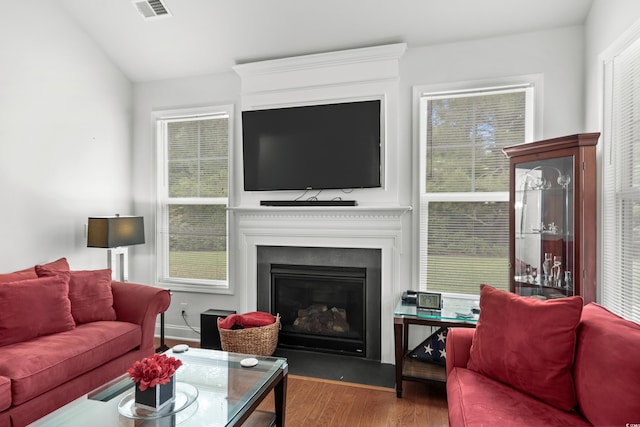 4246 Livorn Loop, Myrtle Beach, SC 29579 - living room with vaulted ceiling, a large fireplace, visible vents, and wood finished floors