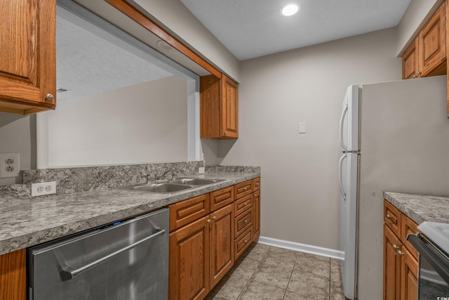 900 Courtyard Dr Unit K7, Myrtle Beach, SC 29577 - kitchen featuring range, dishwasher, baseboards, a sink, and brown cabinets