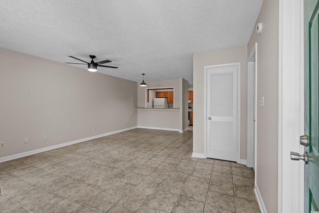 900 Courtyard Dr Unit K7, Myrtle Beach, SC 29577 - unfurnished living room featuring a ceiling fan, baseboards, light tile patterned floors, and a textured ceiling