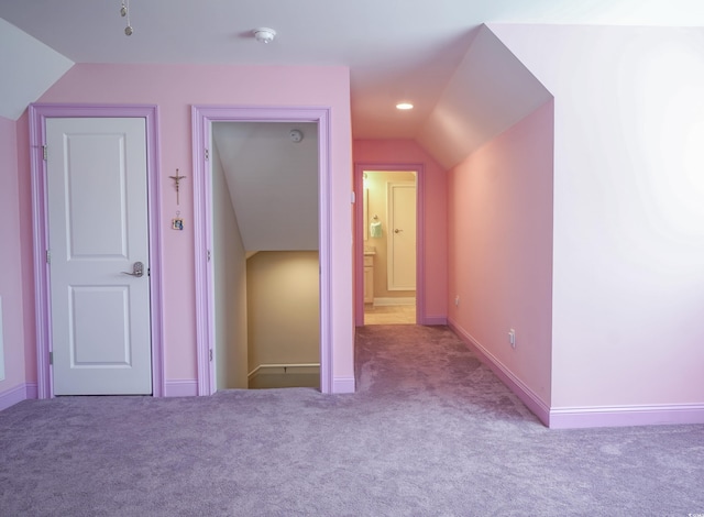 additional living space featuring lofted ceiling, baseboards, recessed lighting, and carpet floors