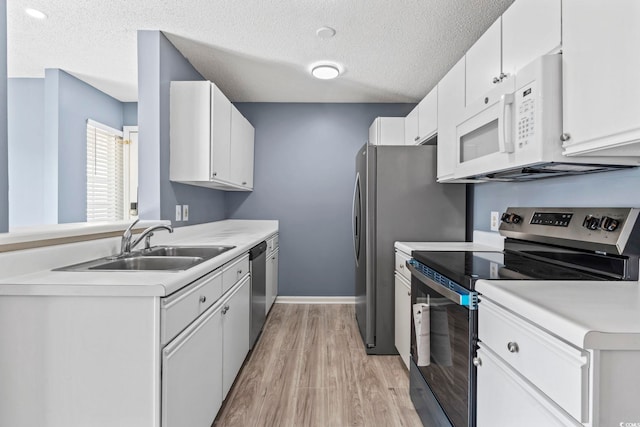 2258 Essex Dr Unit G, Surfside Beach, SC 29575 - kitchen featuring light wood finished floors, a sink, stainless steel appliances, a textured ceiling, and light countertops