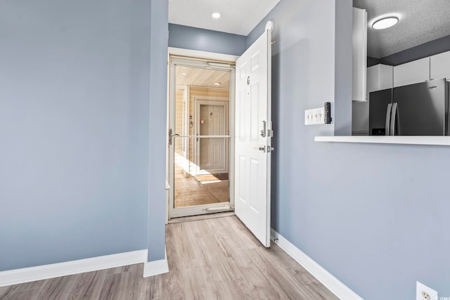 2258 Essex Dr Unit G, Surfside Beach, SC 29575 - interior space featuring baseboards, light wood finished floors, and a textured ceiling
