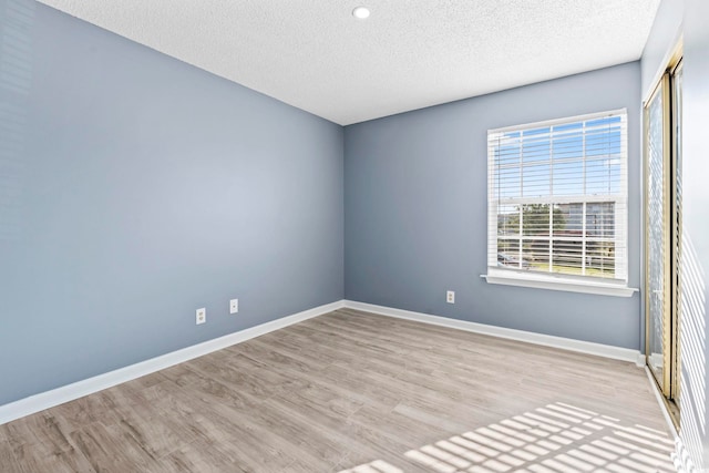 2258 Essex Dr Unit G, Surfside Beach, SC 29575 - empty room featuring a textured ceiling, wood finished floors, baseboards, and recessed lighting