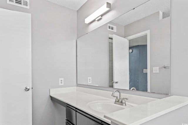 2258 Essex Dr Unit G, Surfside Beach, SC 29575 - bathroom featuring a textured ceiling, visible vents, and vanity