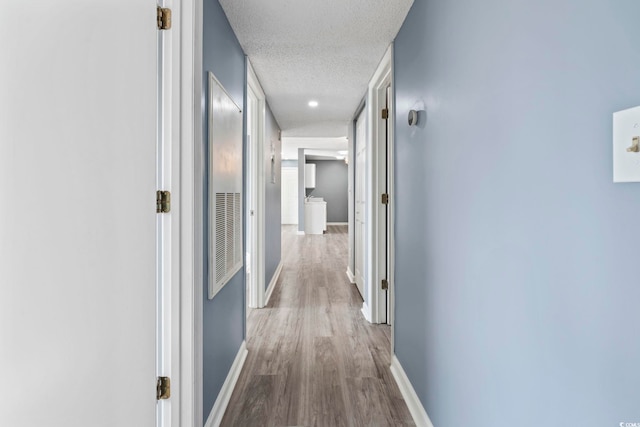 2258 Essex Dr Unit G, Surfside Beach, SC 29575 - hallway with a textured ceiling, baseboards, and wood finished floors