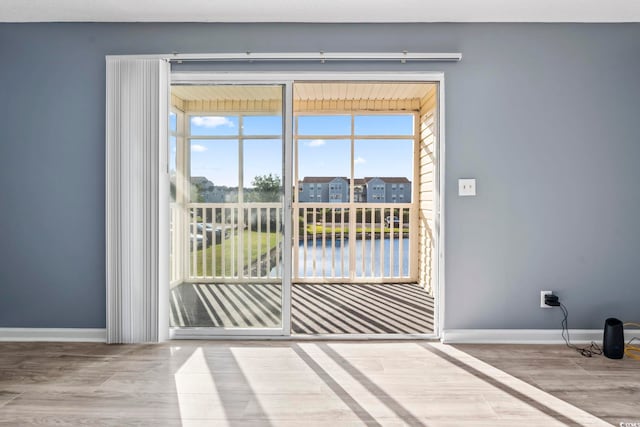 2258 Essex Dr Unit G, Surfside Beach, SC 29575 - doorway featuring a water view, baseboards, and wood finished floors
