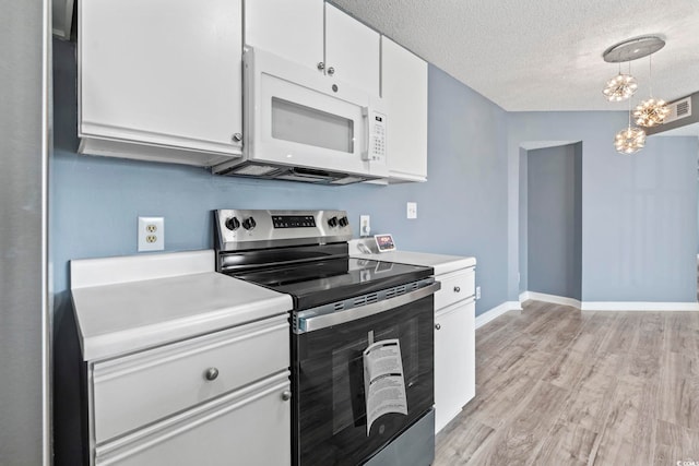 2258 Essex Dr Unit G, Surfside Beach, SC 29575 - kitchen featuring light wood finished floors, electric range, white cabinets, and white microwave