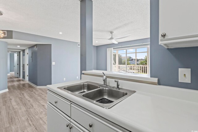 2258 Essex Dr Unit G, Surfside Beach, SC 29575 - kitchen with light countertops, light wood-style flooring, and a textured ceiling