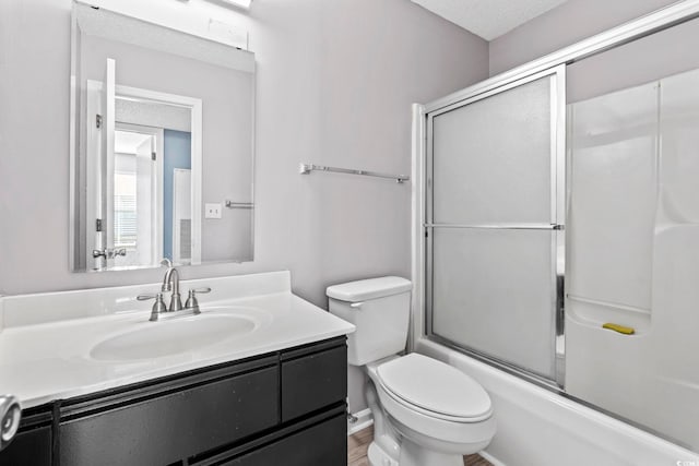 2258 Essex Dr Unit G, Surfside Beach, SC 29575 - full bath with vanity, toilet, bath / shower combo with glass door, and wood finished floors