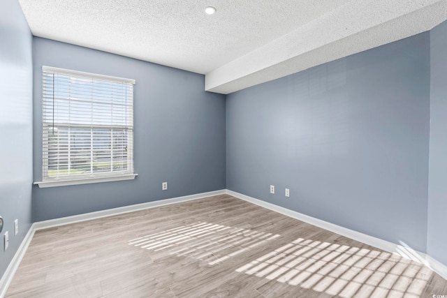 2258 Essex Dr Unit G, Surfside Beach, SC 29575 - empty room featuring a textured ceiling, baseboards, and wood finished floors
