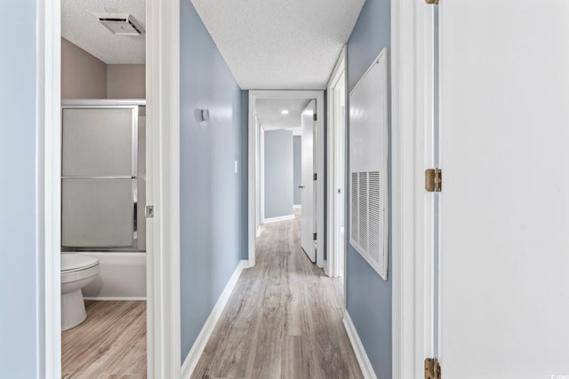 2258 Essex Dr Unit G, Surfside Beach, SC 29575 - hallway with a textured ceiling, visible vents, wood finished floors, and baseboards