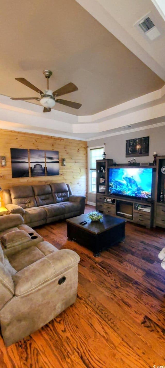 1717 Perdiz Covey Ct, Myrtle Beach, SC 29588 - living room featuring a tray ceiling, wood finished floors, a ceiling fan, and wooden walls