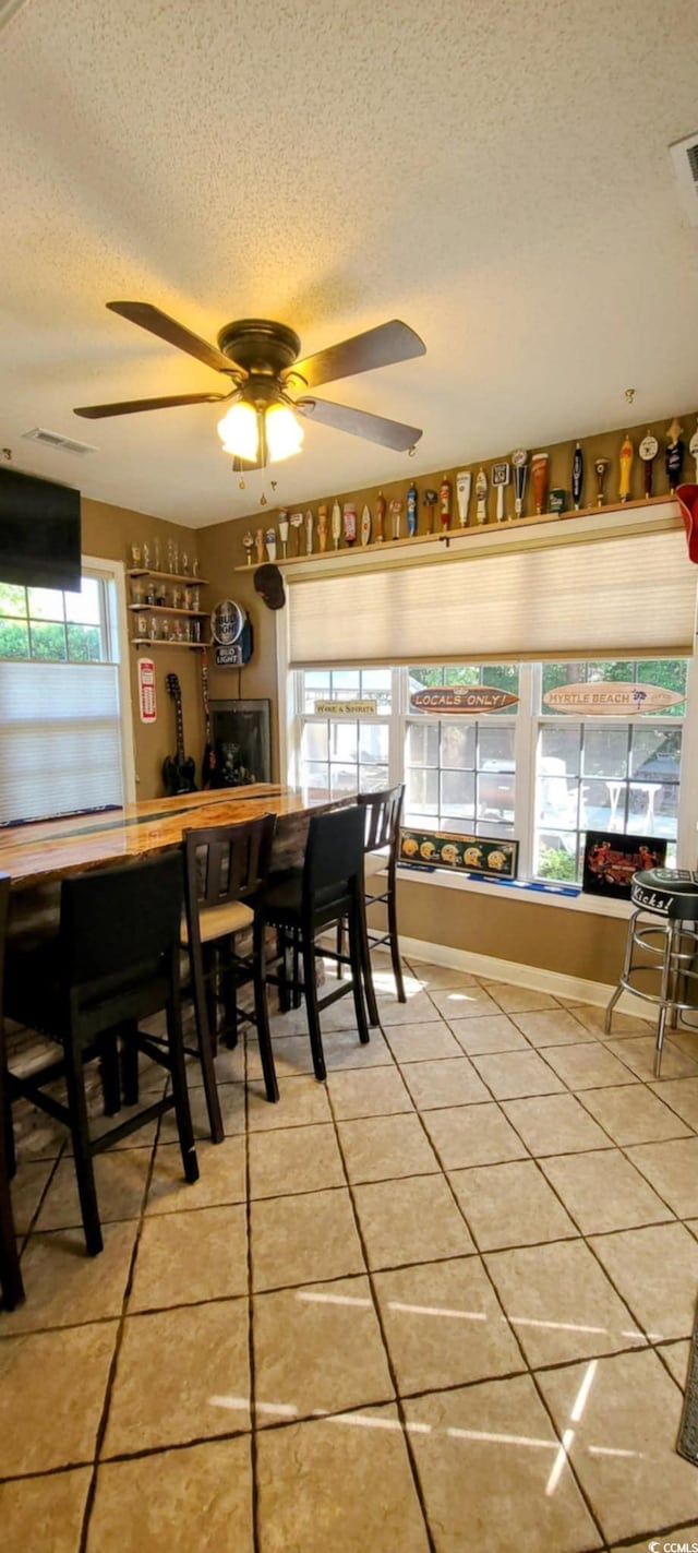 1717 Perdiz Covey Ct, Myrtle Beach, SC 29588 - dining room with a textured ceiling, light tile patterned floors, a ceiling fan, and baseboards