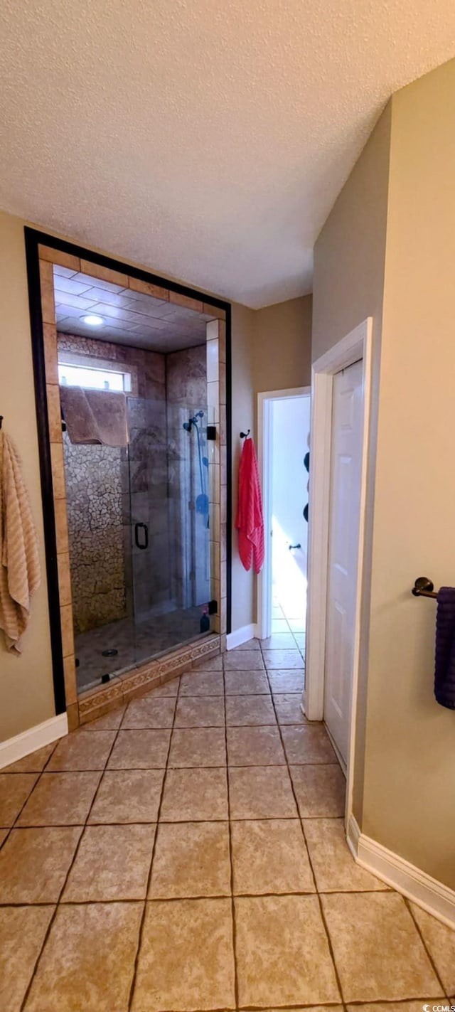1717 Perdiz Covey Ct, Myrtle Beach, SC 29588 - full bath with a stall shower, a textured ceiling, baseboards, and tile patterned flooring