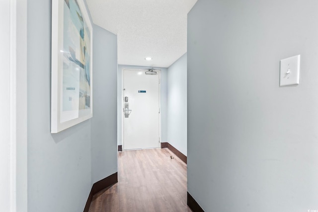 205 74th Ave N Unit 1104, Myrtle Beach, SC 29572 - hall with wood finished floors, baseboards, and a textured ceiling