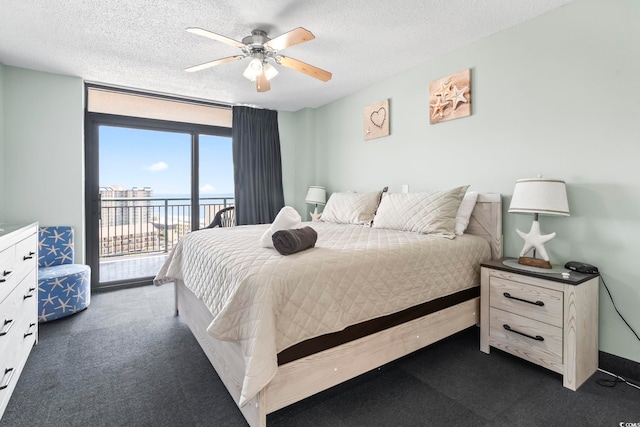 205 74th Ave N Unit 1104, Myrtle Beach, SC 29572 - bedroom featuring access to outside, dark colored carpet, a textured ceiling, and ceiling fan
