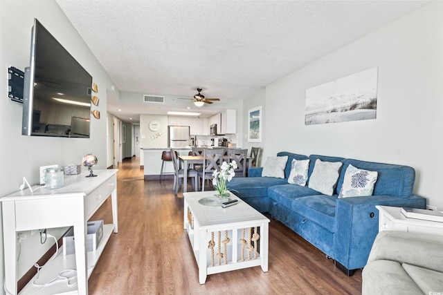 205 74th Ave N Unit 1104, Myrtle Beach, SC 29572 - living area featuring a ceiling fan, wood finished floors, and a textured ceiling