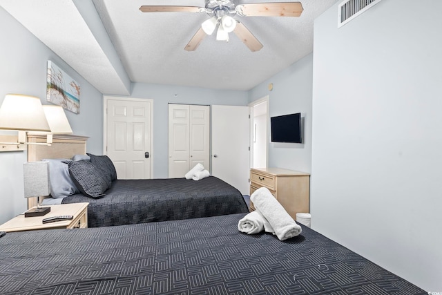 205 74th Ave N Unit 1104, Myrtle Beach, SC 29572 - bedroom with carpet flooring, a ceiling fan, a closet, and a textured ceiling