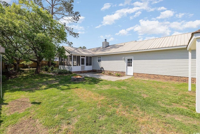 706 Chippendale Dr, Myrtle Beach, SC 29588 - rear view of property with a yard, fence, a patio, a sunroom, and a fire pit
