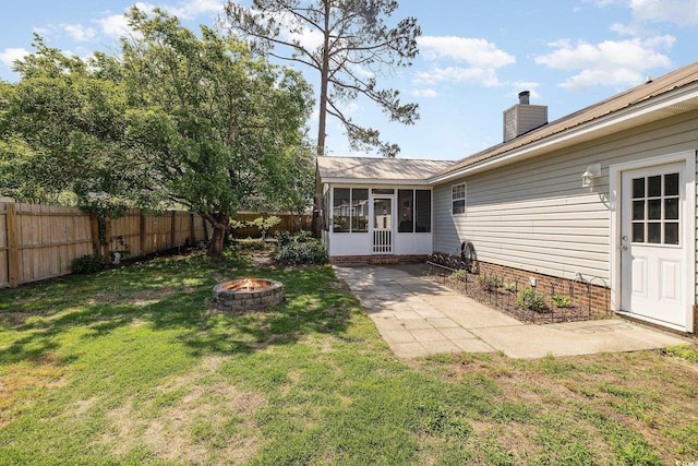 706 Chippendale Dr, Myrtle Beach, SC 29588 - view of yard with a fenced backyard, an outdoor fire pit, and a sunroom
