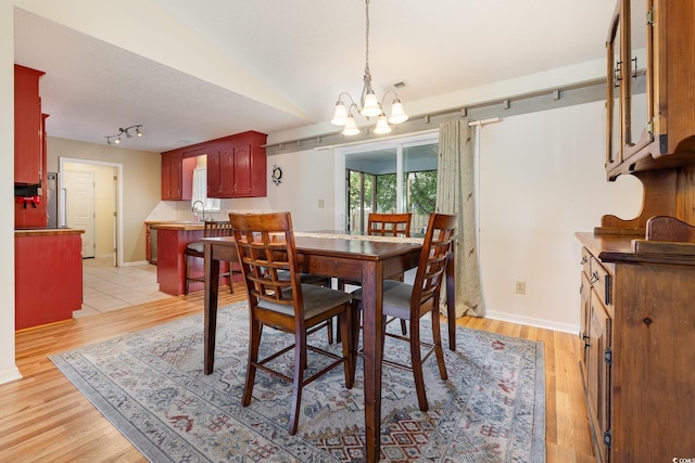 706 Chippendale Dr, Myrtle Beach, SC 29588 - dining space with a chandelier, light wood-style flooring, baseboards, and track lighting