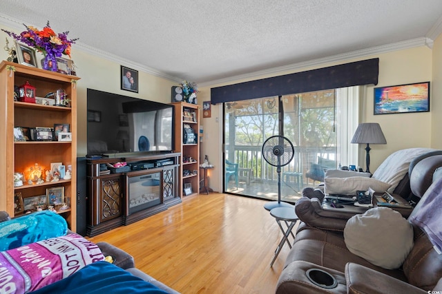 living room featuring crown molding, a textured ceiling, and wood finished floors