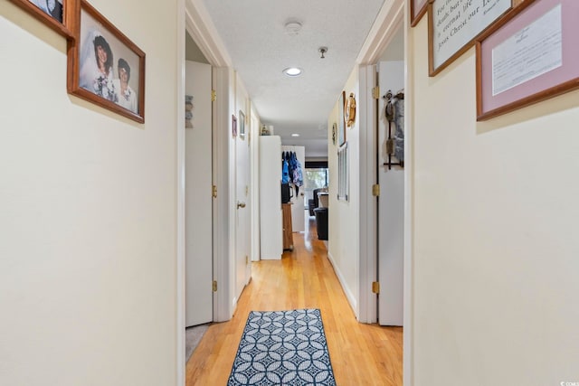 hall featuring light wood-style floors and recessed lighting