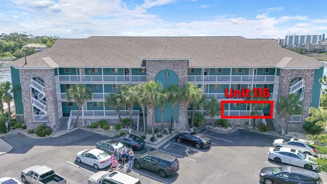 view of building exterior with uncovered parking