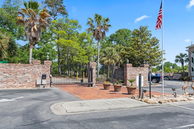 view of street with street lighting, a gated entry, and a gate