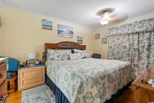bedroom with crown molding, light wood-style flooring, and a textured ceiling