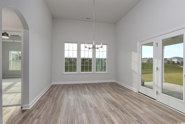 4031 Bucolic Loop, Myrtle Beach, SC 29588 - unfurnished dining area with arched walkways, wood finished floors, a chandelier, and baseboards