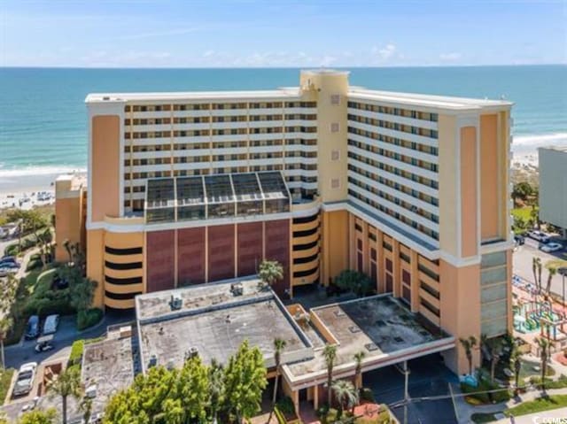 view of property with view of water and beach