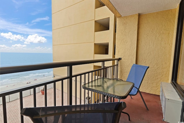 balcony with view of water and beach