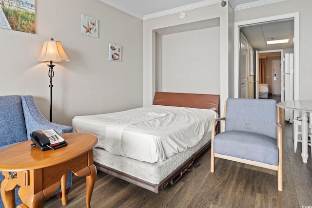 bedroom with wood finished floors, ornamental molding, and freestanding refrigerator