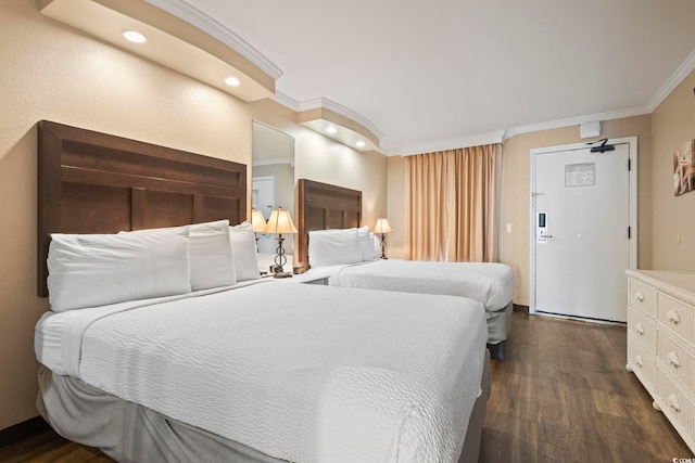 bedroom with dark wood-type flooring, ornamental molding, and recessed lighting