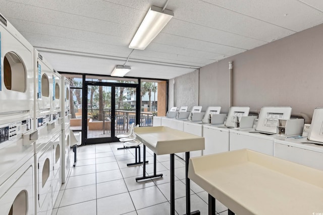 shared laundry room with estacked washer and dryer, washing machine and dryer, french doors, and light tile patterned flooring