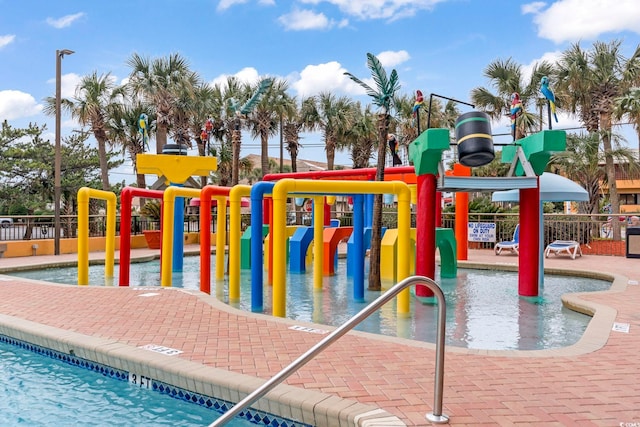 communal playground featuring a water play area and fence