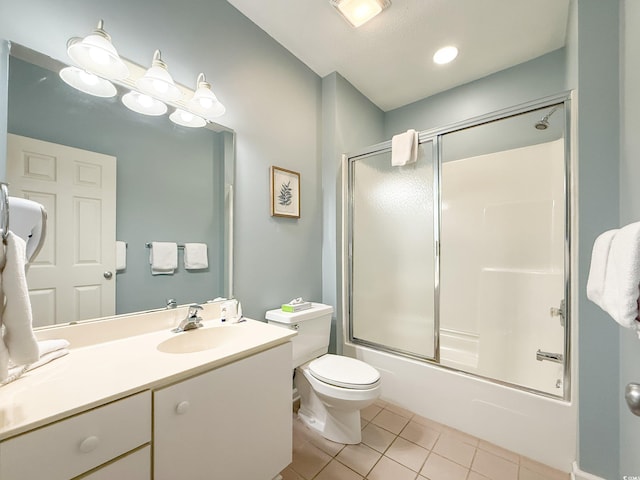 bathroom featuring bath / shower combo with glass door, toilet, tile patterned flooring, and vanity